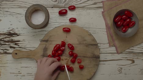 tomato slicing on wooden cutting board