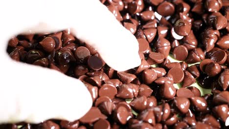 hand sorting chocolate chips with precision