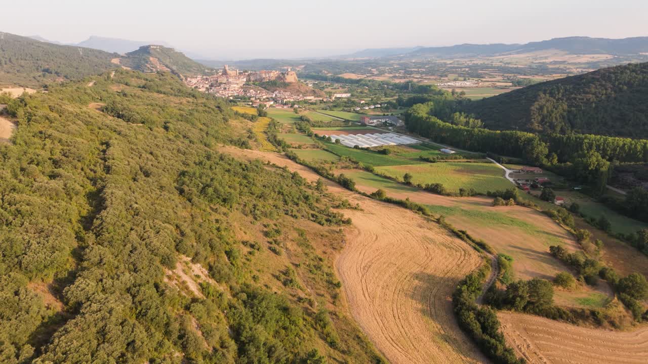 Approaching drone shot of farmlands, villages, and a scenic countryside in Valderama in the province of Burgos in Spain.