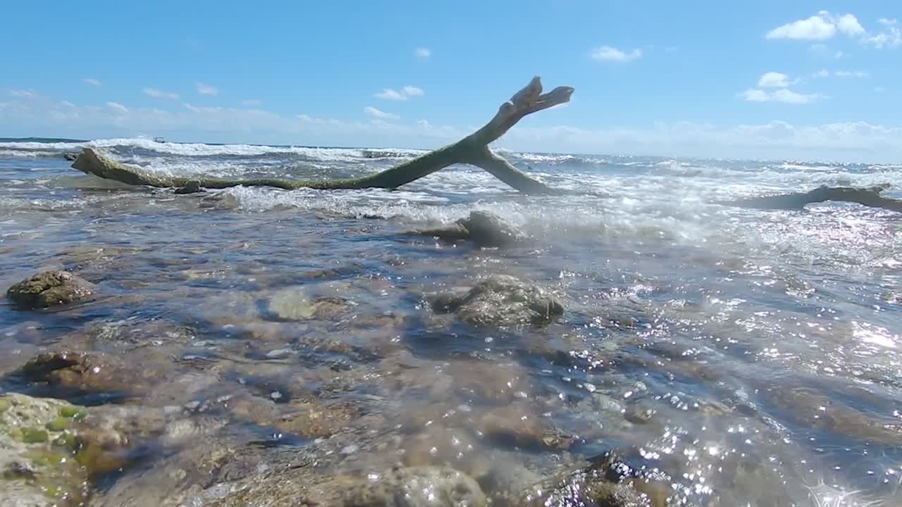 Waves rolling into a sunny beach in the Riviera Maya, Quintana Roo, Mexico