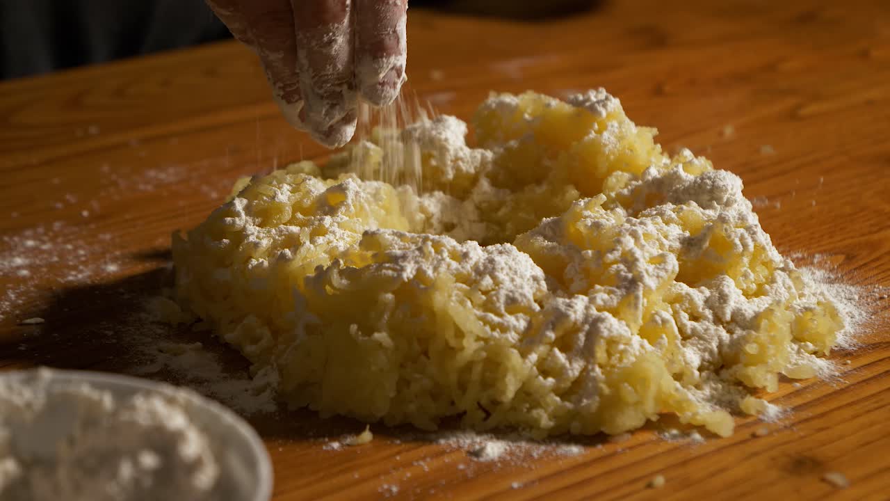 4K close up slow motion shot white flour poured into a heap of mashed potatoes on a wooden table