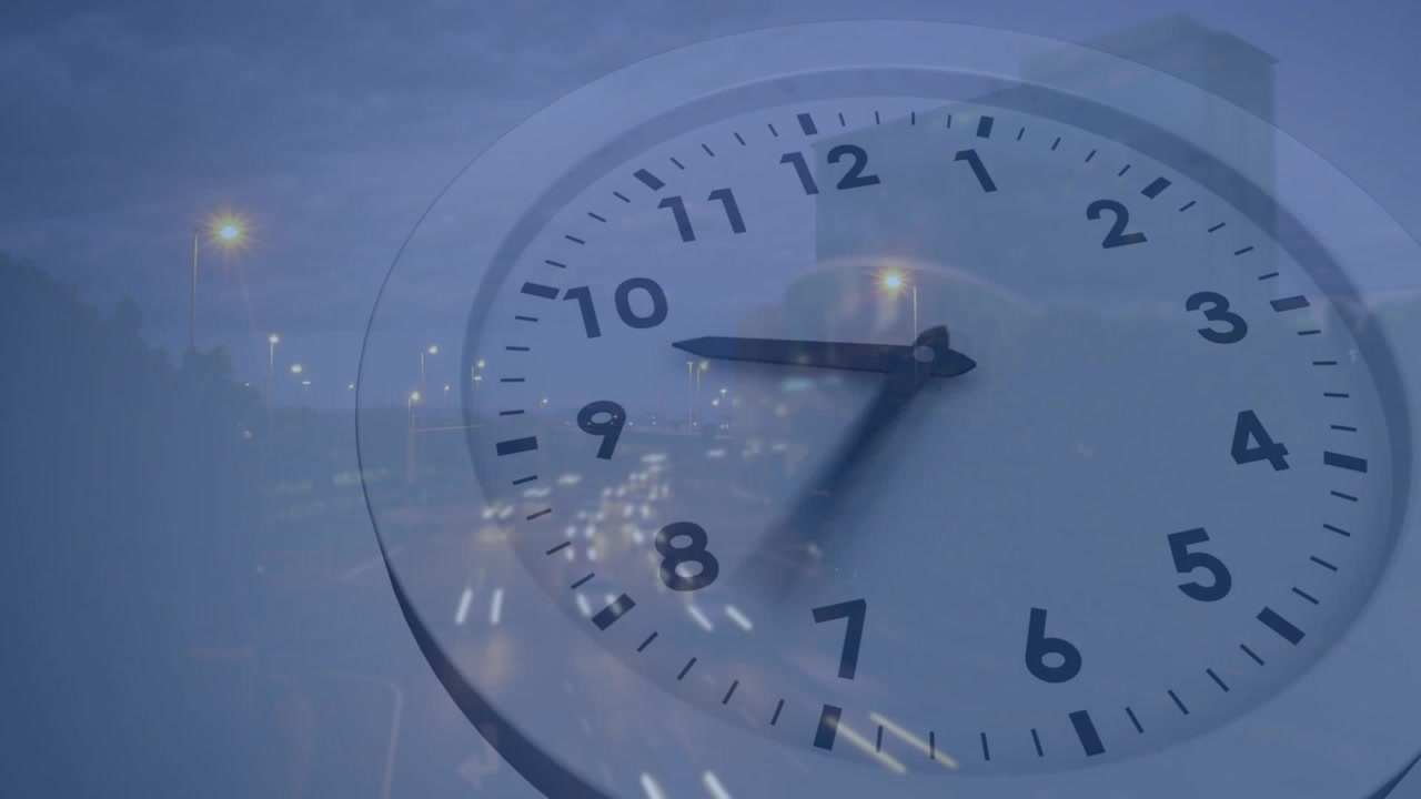 Avance de fotogramas haciendo que las manecillas de un reloj analógico giren en sentido horario mientras estelas de tráfico muestran el tiempo