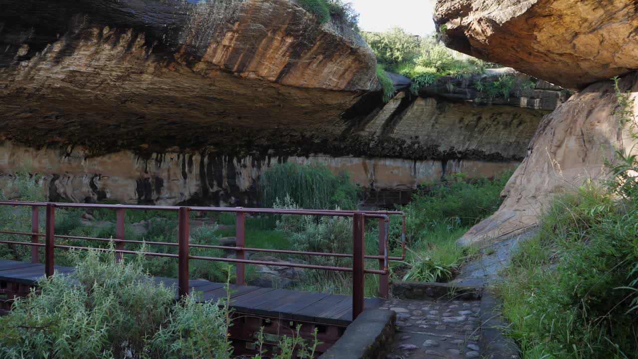 Tourism pan along trail in Lesotho Africa's Liphofung Cave canyon