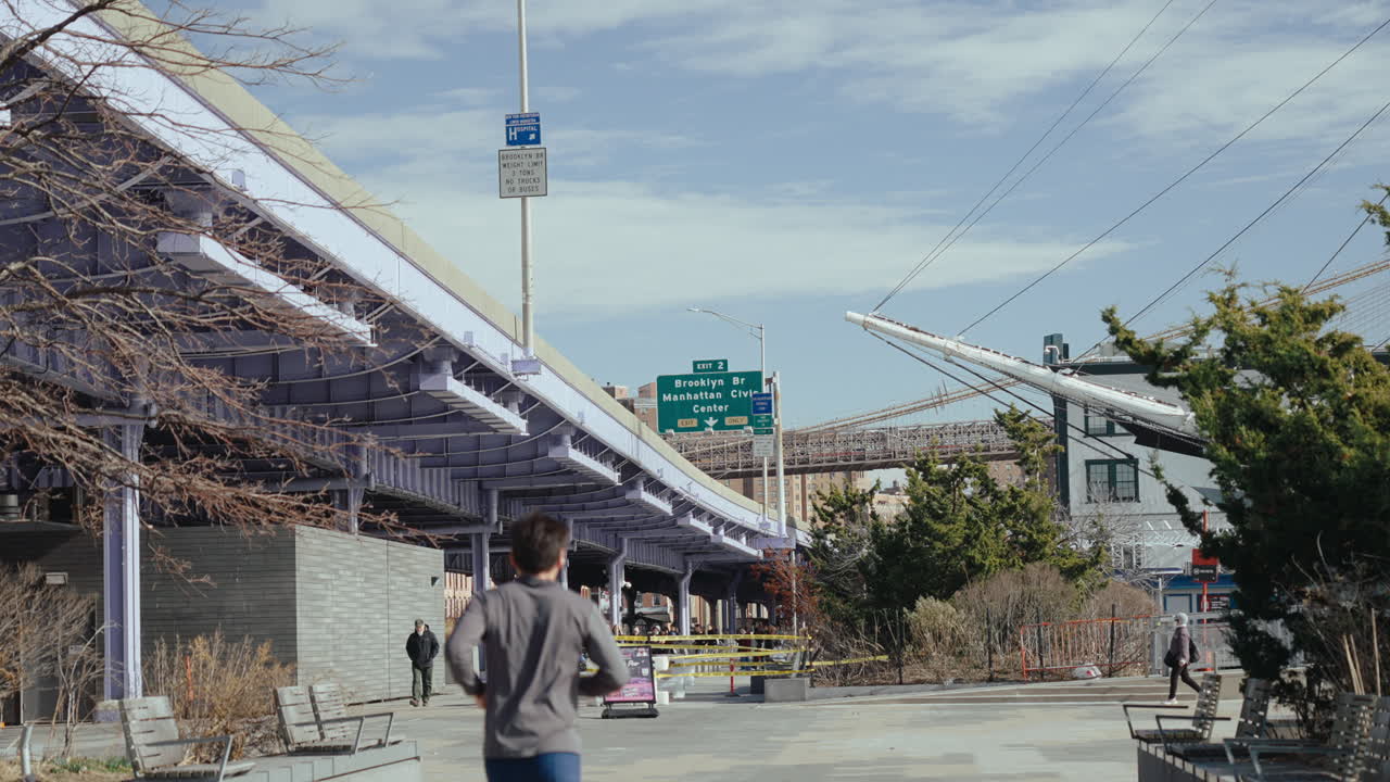 Urban Park Scene in Brooklyn with Running Figure and City Views