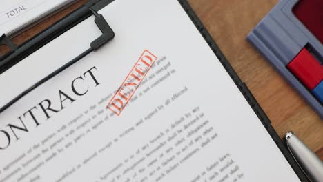 contract document with denied stamp