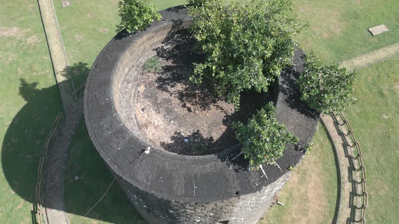 Mauritius - Port Louis -flyng hover with tilt down on round stone defence tower Martello type