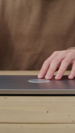 person using a smartphone and a laptop with wireless charging