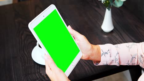 mujer de negocios usando una tableta digital mientras toma café