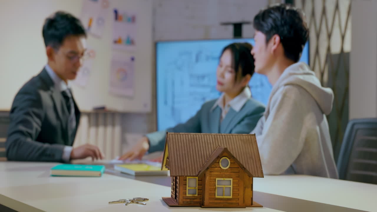 Discussion With real estate broker or sales representative advising a client on the purchase of a home and drafting a contract. Discussing design project of new house, choosing color palette