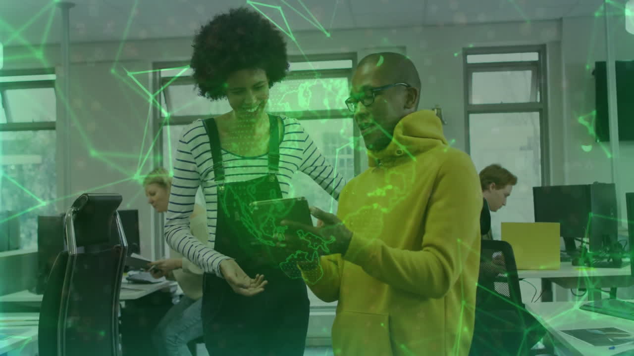 Collaborating on tablet, two people with green digital network animation overlay