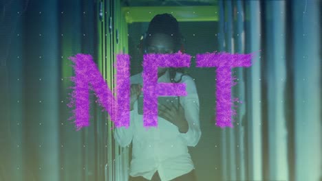 animation of nft text over african american woman using headphones server room