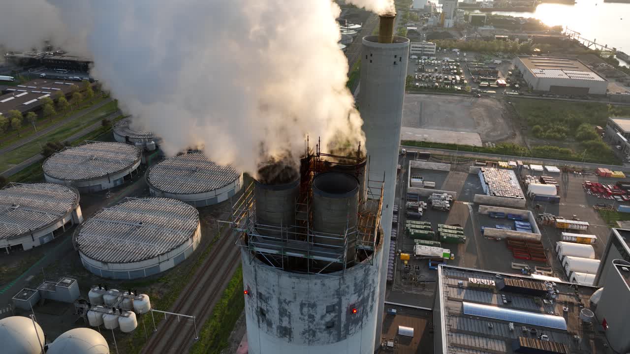 Close up view on smoking, steaming, chimney, industrial facility, factory, carbon emission, heavy industry. Industrial waste. Aerial close up view.