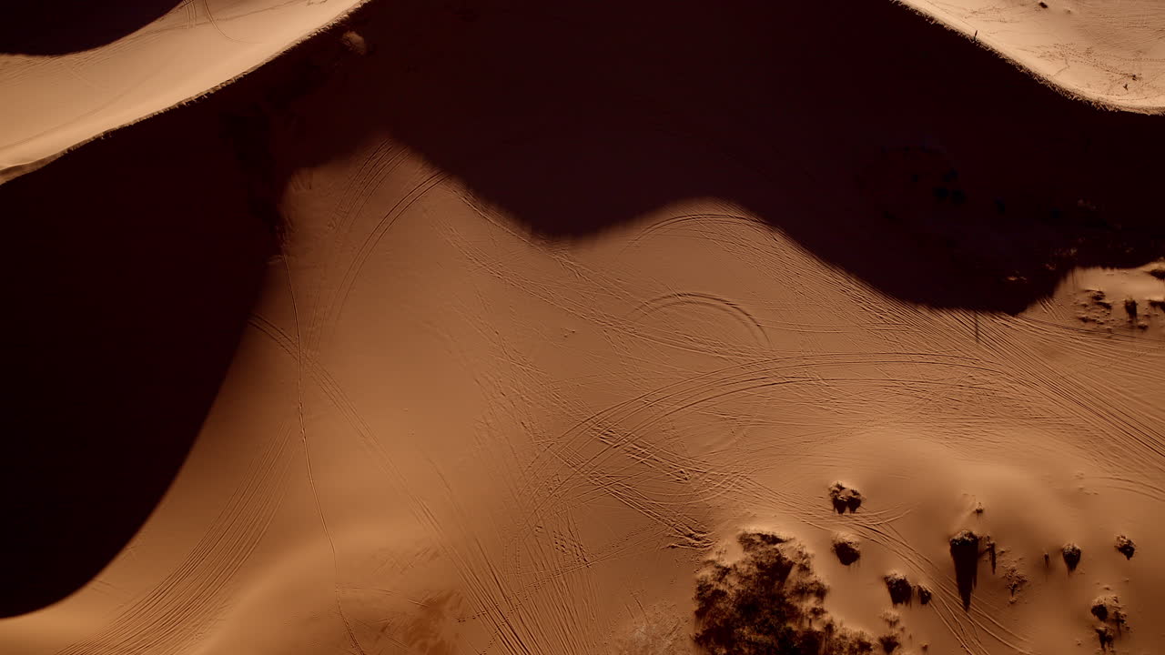 Ethereal overhead view of natural shapes and sweeping lines in Utah’s desert dunes.