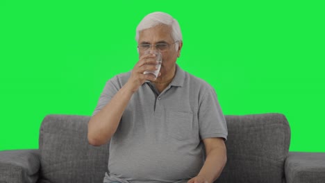 Sick-Indian-old-man-taking-medicine-Green-screen