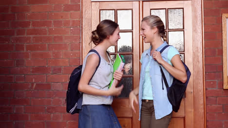 classmates meeting in hallway and hugging