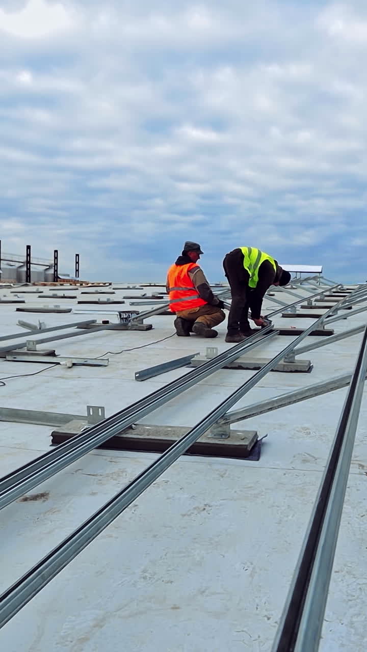 Installation of renewable green energy. Solar panel technician installing metal platform