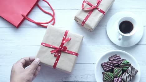 gifts, coffee, and brownies on a white wooden table