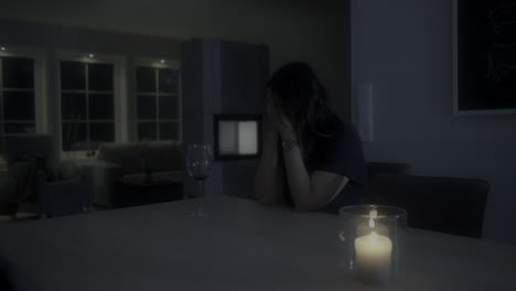 medium shot of woman with empty glass feeling strong anxiety or depression at night, panning slider