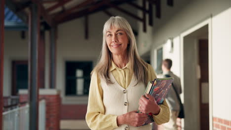 a woman holding books in a school hallway