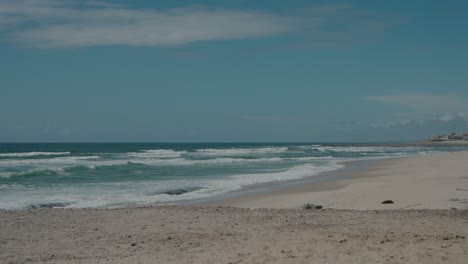 Sunny-day-at-Ovar-Beach,-Aveiro,-Portugal-with-waves-and-clear-blue-sky