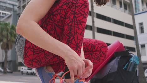 caucasian woman tying her shoelaces