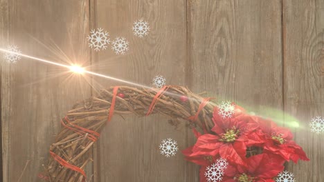 Animation-of-light-trails-and-snowflakes-over-decorations-at-christmas