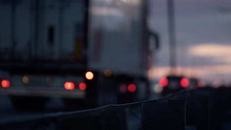 closeup road metallic guardrail at purple evening sky. city traffic security.