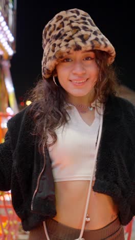 joyful young woman at a night fair