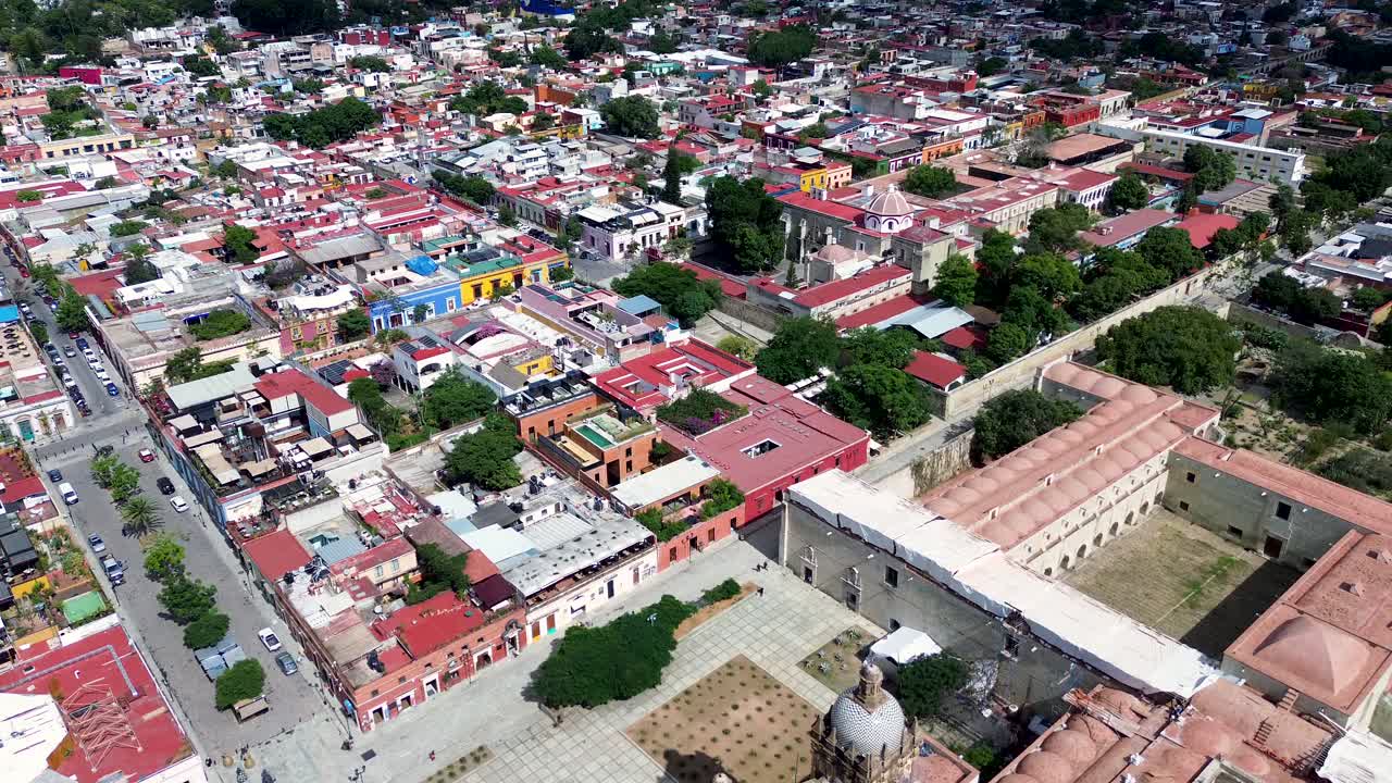 Drone aerial landscape old town square with cultural museum landmark buildings and housing streets shops and restaurants Oaxaca city Mexico travel holidays tourism
