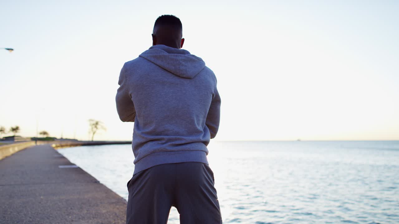 African American male stretching and resting in sportswear