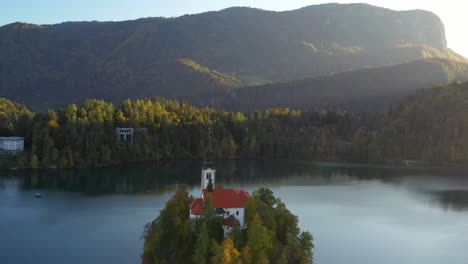 revealing drone shot of the pilgrimage church of the assumption of mary, slovenia