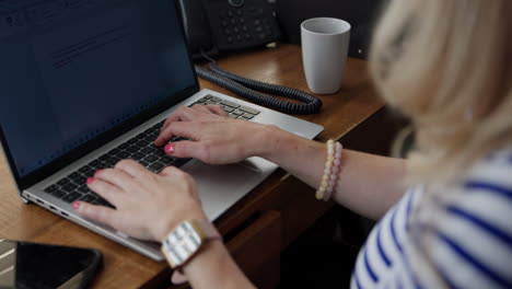 woman typing on a laptop at a desk