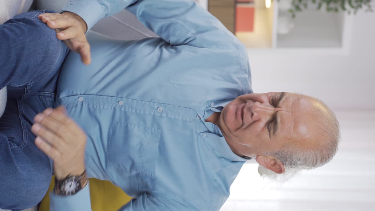 Vertical video of Frustrated old man gets angry.