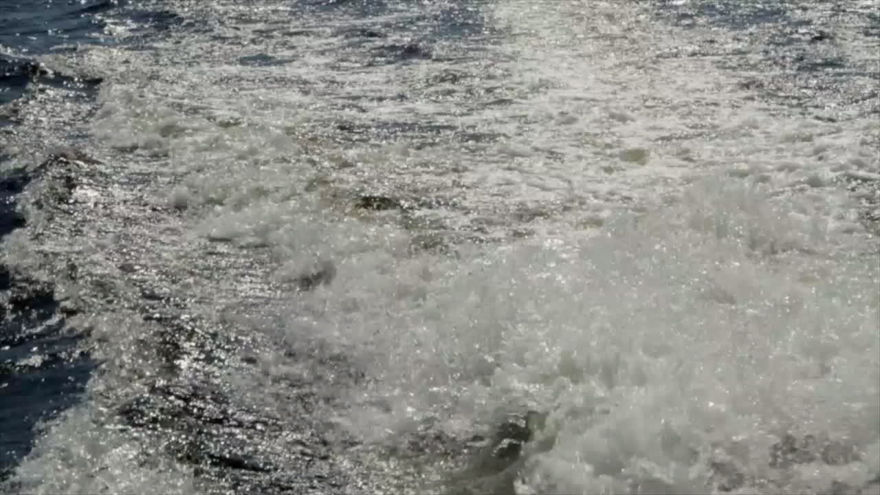 This is a shot of water churning from behind a boat as it travels around a lake