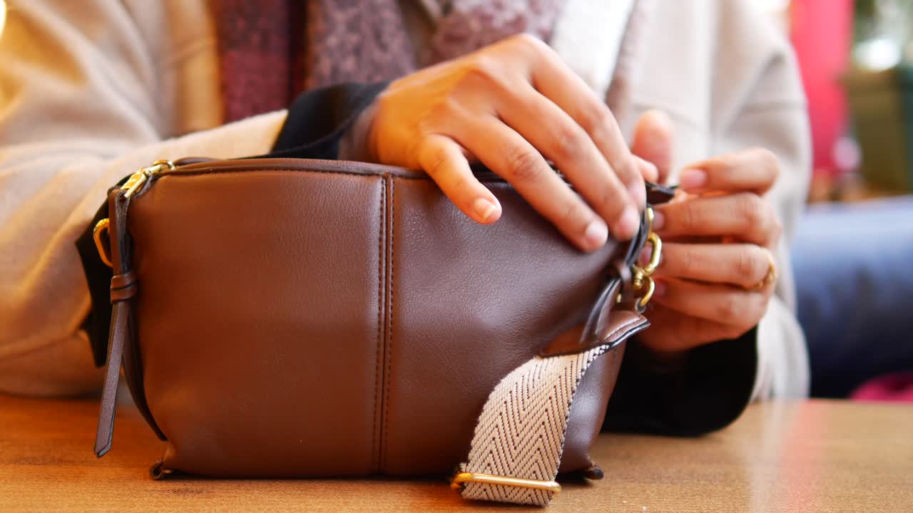 Woman taking items from her bag