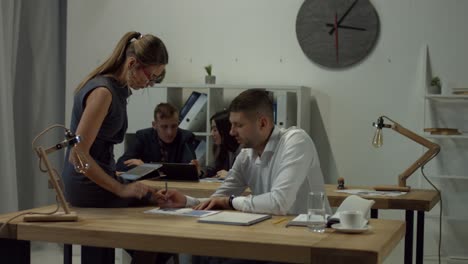 two business colleagues discussing graph in office