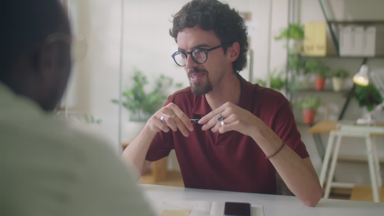 Man Discussing Business Plan with Colleague in Office
