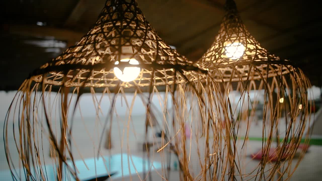 circling footage of hanging lamps at beach lounge
