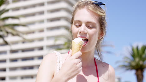 close up portrait young woman eating ice cream in the summer on vacation