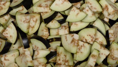 eggplant slices on black. top view. loop motion. rotation 360.