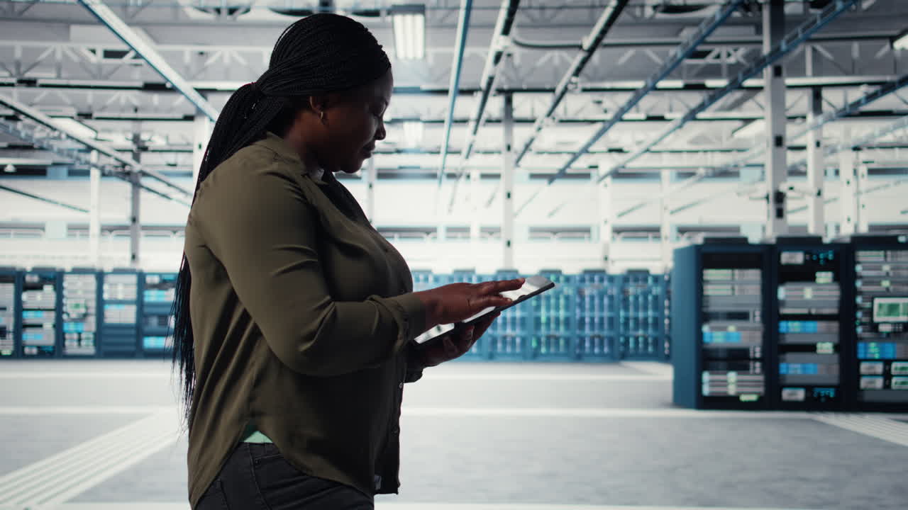 Developer in data center using tablet to increase workload capacity