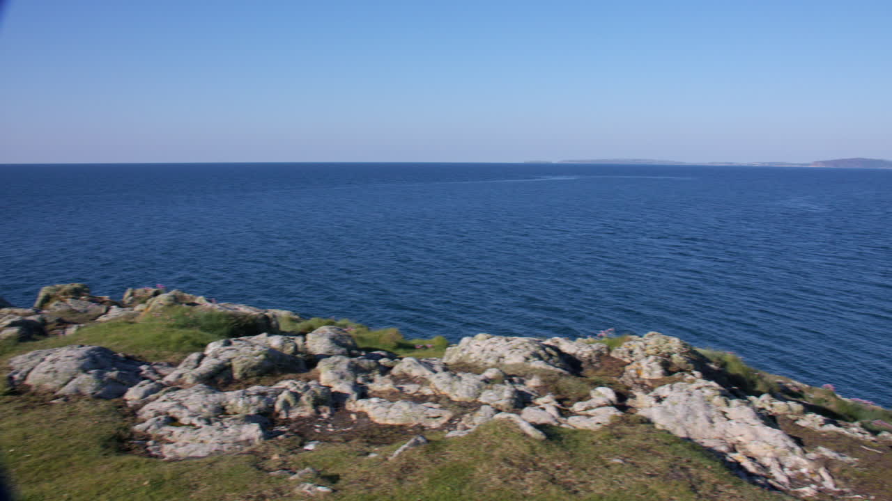 wide panning shot of the headland at Hafan y Môr on Pen-y-chain, Pwllheli