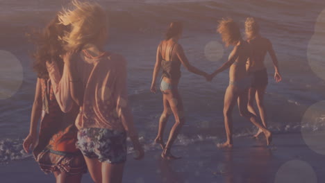 group of friends walking on beach over bokeh lights animation