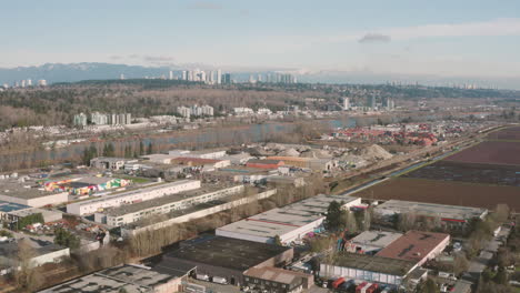 aerial flying over an industrial neighbourhood along the fraser river in richmond, greater vancouver