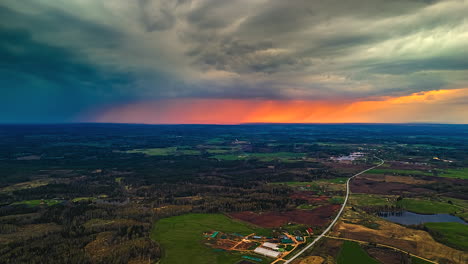 aerial time-lapse of dramatic sunset, rain clouds moving over the countryside