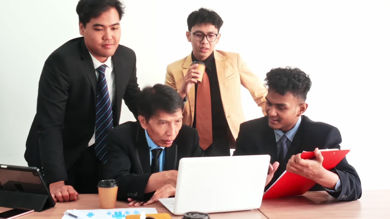 Diverse business team collaborates on laptop presentation discussing strategy for success and growth