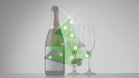 video compuesto digital del árbol de navidad hecho de triángulos verdes contra una botella de champán