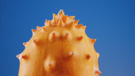 Close-up-of-Spinning-Kiwano-Melon-on-a-Blue-Screen,-Loopable-Chroma-Key