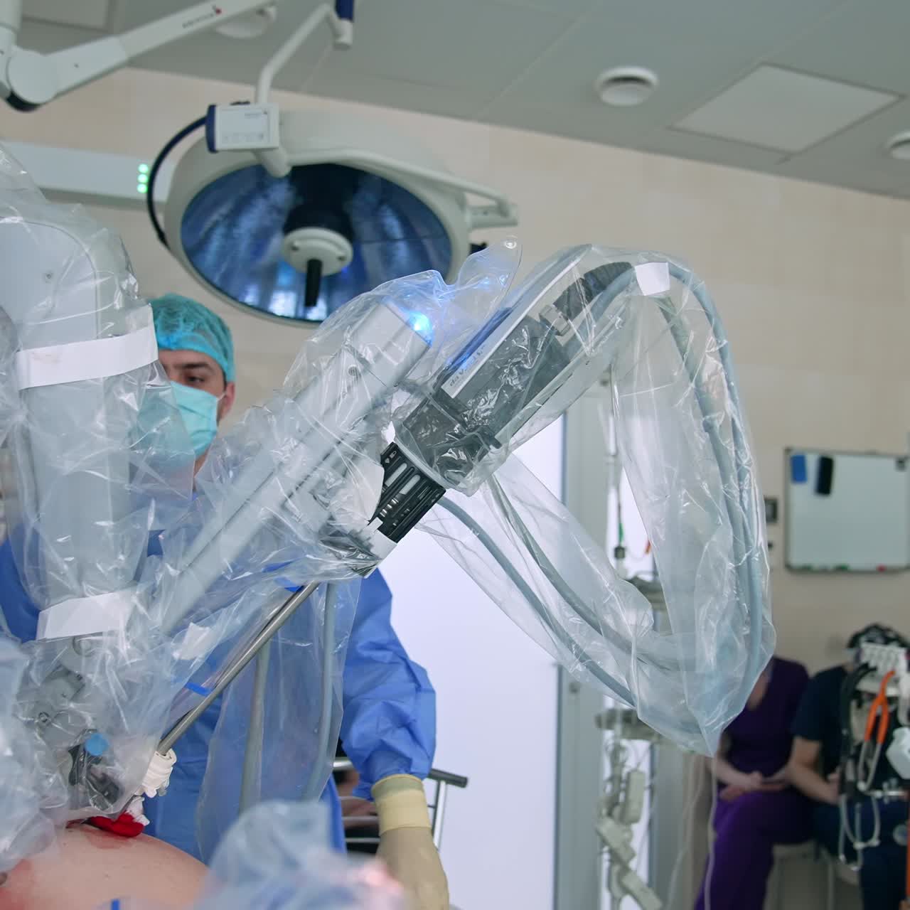 Working Da Vinci robot in the middle of modern surgery room. Circle movement around the equipment. Surgeon controlling the procedure