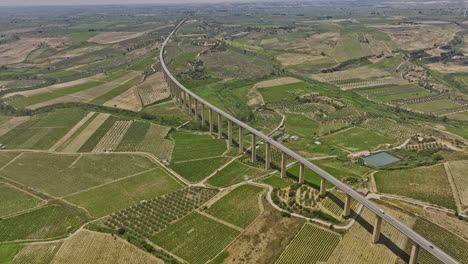 Borgo-Vecchio-Italy-Aerial-v1-birds-eye-view-drone-flyover-country-town-capturing-vast-farmlands-and-vineyards,-with-a-highway-bridge-spanning-across-the-landscape---Shot-with-Mavic-3-Cine---June-2023